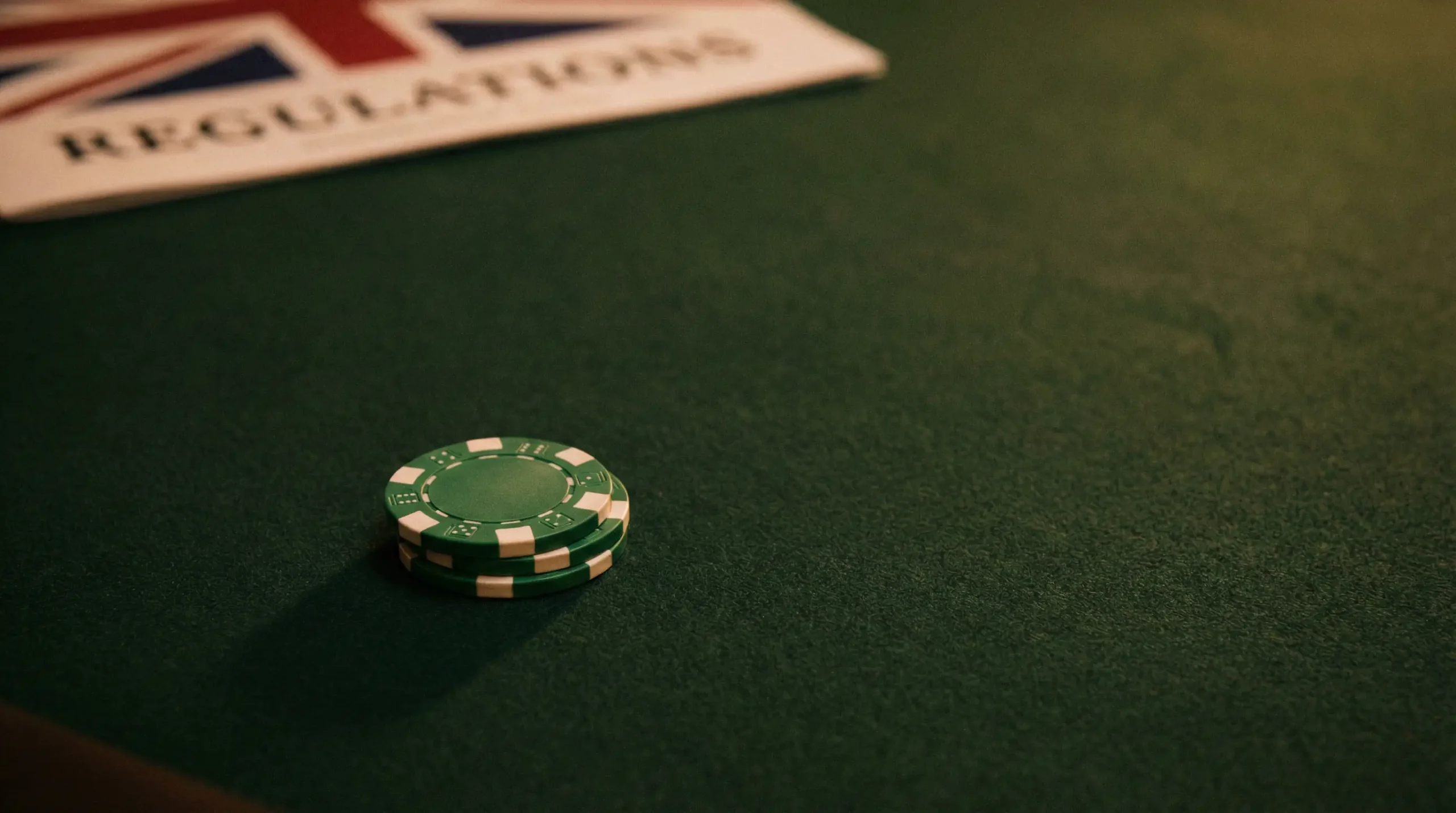 UK online gambling regulation and player protection concept with green gaming table felt and British licensing elements